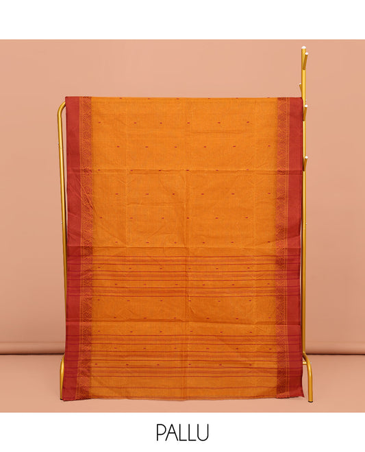 Orange Bengal Cotton Saree, Subtly Sparkled with Buttas All Over Its Body, Complemented by a Contrast Border of Unique Designs, Pallu of Stripes and Buttas, and Paired with a Matching Blouse