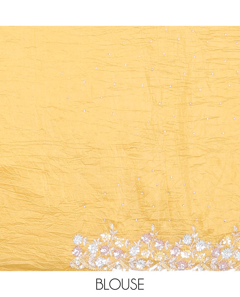 Yellow designer saree with stone embroidery throughout the body and pallu, scallop floral embroidery border