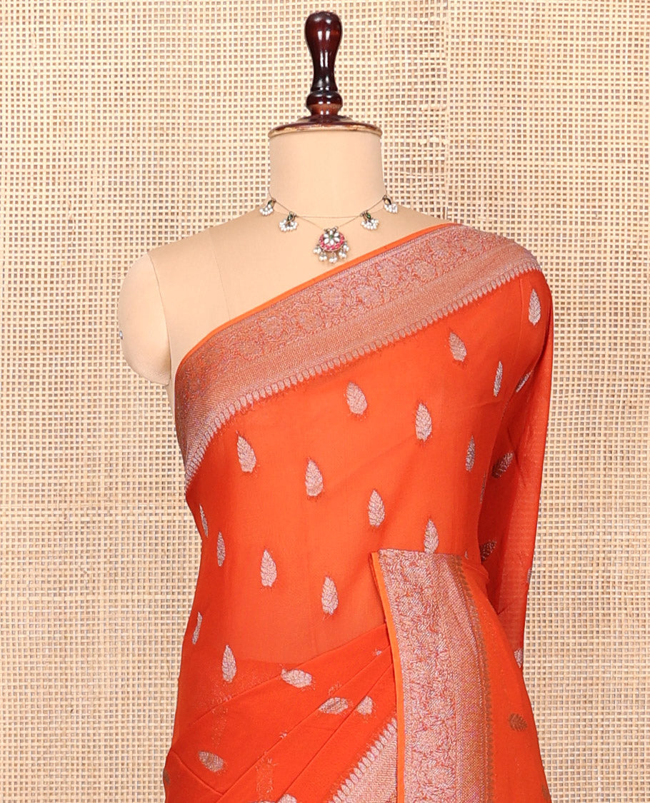 Orange Georgette Saree, Steeped with Buttas, Highlighted by a Traditional Floral Creeper Border, Intricately Designed Pallu, and  a Matching Blouse