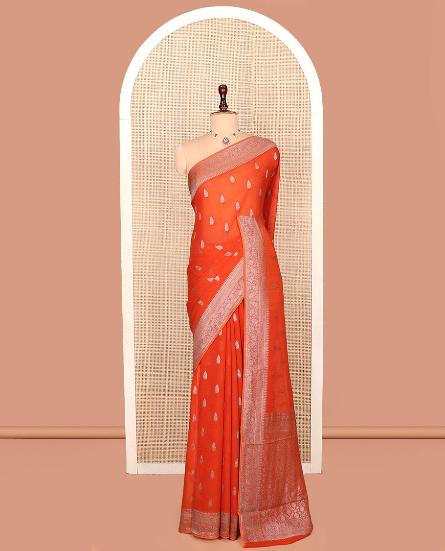 Orange Georgette Saree, Steeped with Buttas, Highlighted by a Traditional Floral Creeper Border, Intricately Designed Pallu, and  a Matching Blouse