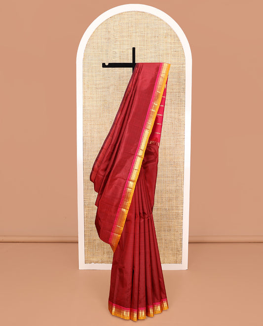 Maroon Plain Kanchipuram Silk Saree, Complemented by a Contrast One-Sided Border of Rekku, Banaras, and Mayil Kann Designs, Pallu of Zari Stripes, and Comes Without a Blouse