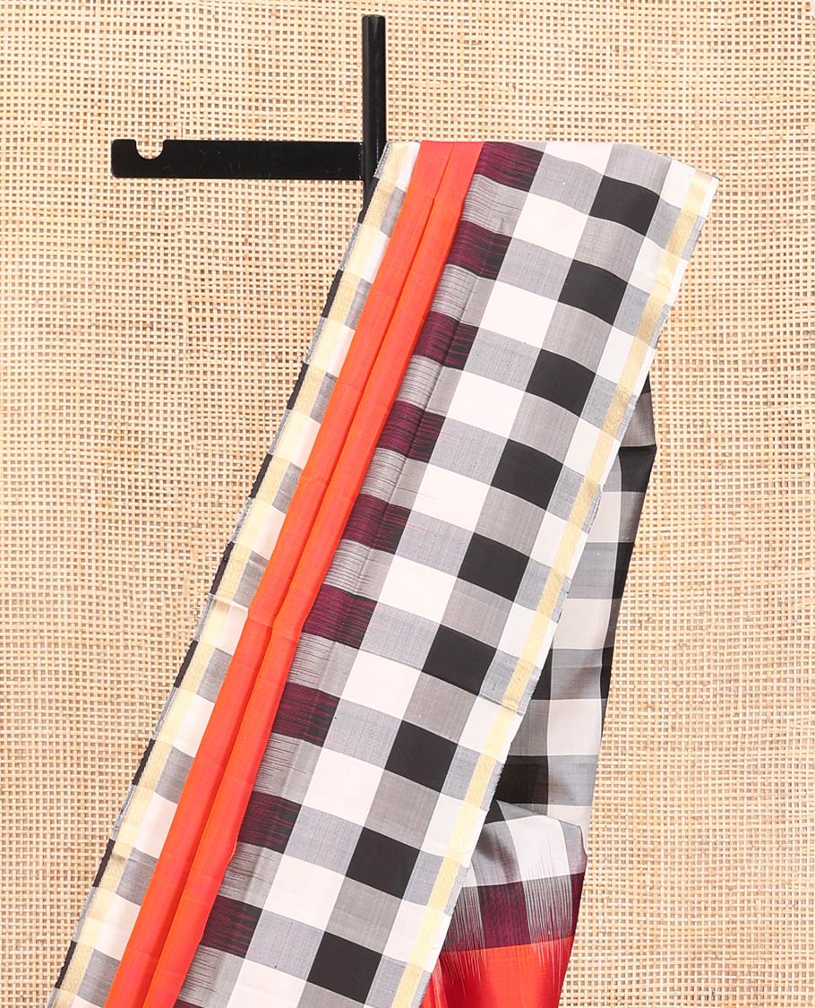Orange Plain Mayuri Soft Silk Saree, Complemented by a Contrast Black-White Chess-Style Checked Border, Chess-Style Checked Pallu, and Paired with a Contrast Blouse