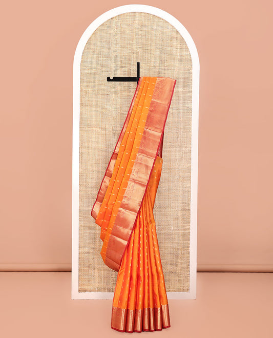 Orange Vasundhara Lite Silk Mix Saree, Decked Up with Zari Buttas All Over Its Body, Complemented by a Contrast Border of Thilakam, Mayil, and Scallop Designs, Grand Jaal-Design Pallu, and Paired with a Contrast Blouse