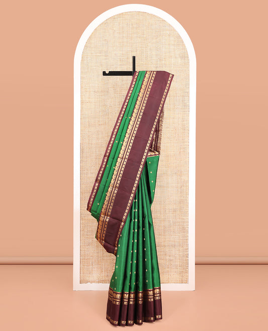 Green Vasundhara Silk Saree, Elevated with Zari Buttas All Over Its Body, Complemented by a Contrast Rettai Pettu Border of Yaanai Designs, Grand Jaal Pallu, and Paired with a Contrast Blouse