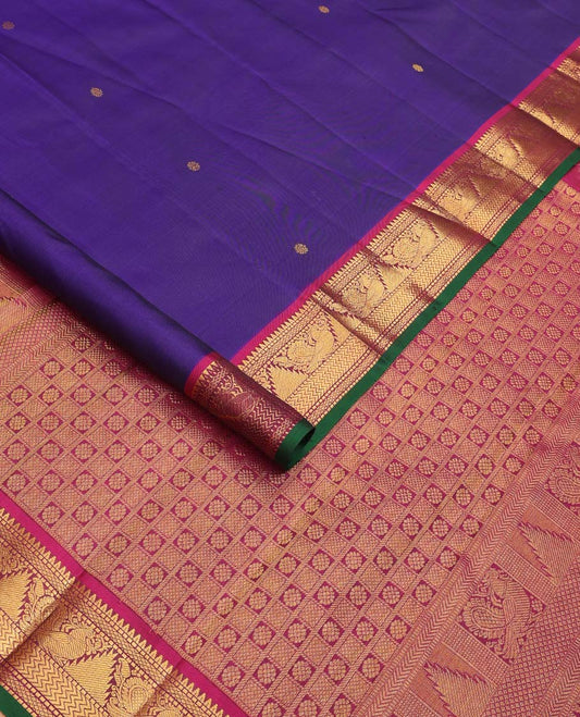 Blue buttas Kanchipuram silksaree, contrast border of rekku,muthu,mayil kann,thazampoo rekku, and mayil, and pallu of laddu kamalam, and mayil kann enclosed checks
