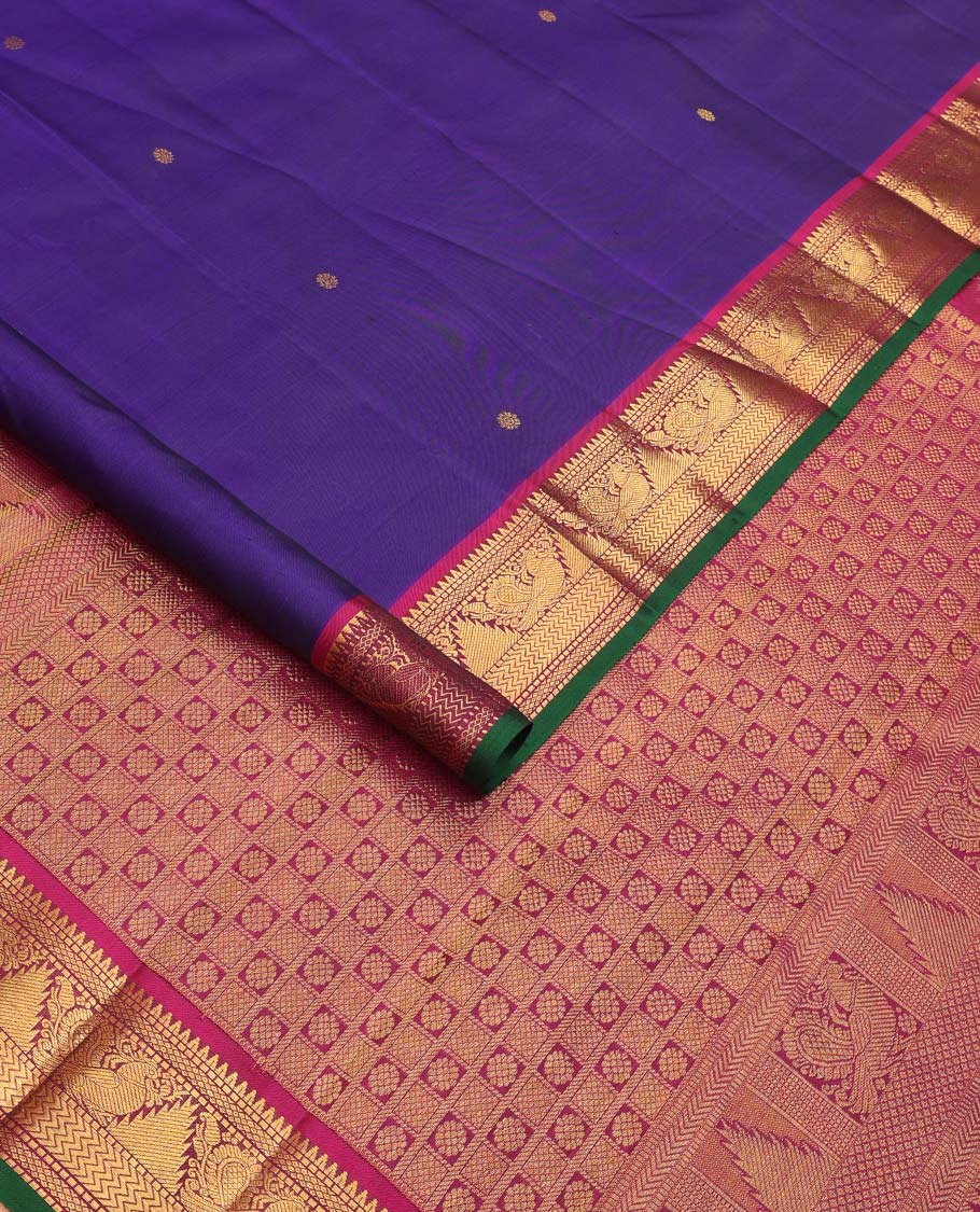 Blue buttas Kanchipuram silksaree, contrast border of rekku,muthu,mayil kann,thazampoo rekku, and mayil, and pallu of laddu kamalam, and mayil kann enclosed checks
