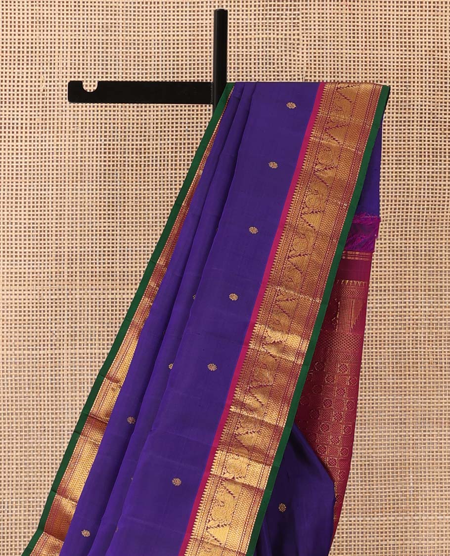 Blue buttas Kanchipuram silksaree, contrast border of rekku,muthu,mayil kann,thazampoo rekku, and mayil, and pallu of laddu kamalam, and mayil kann enclosed checks