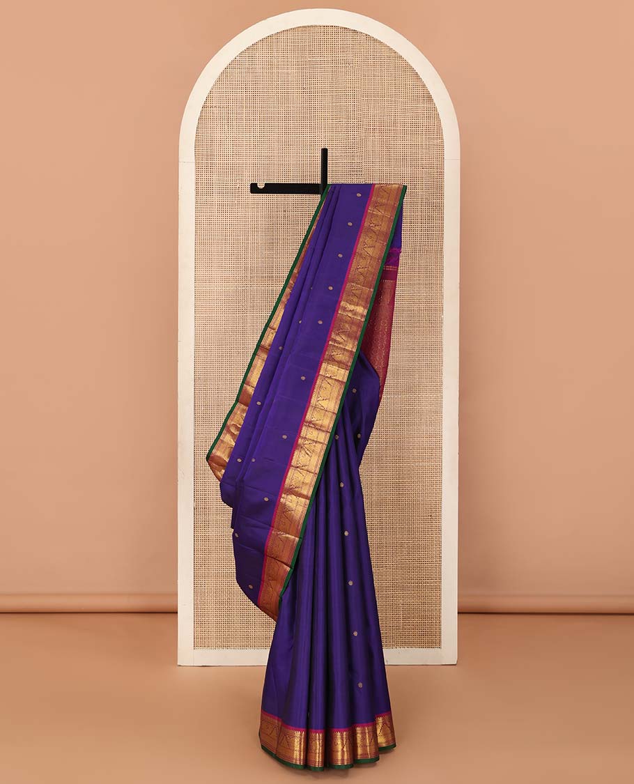 Blue buttas Kanchipuram silksaree, contrast border of rekku,muthu,mayil kann,thazampoo rekku, and mayil, and pallu of laddu kamalam, and mayil kann enclosed checks