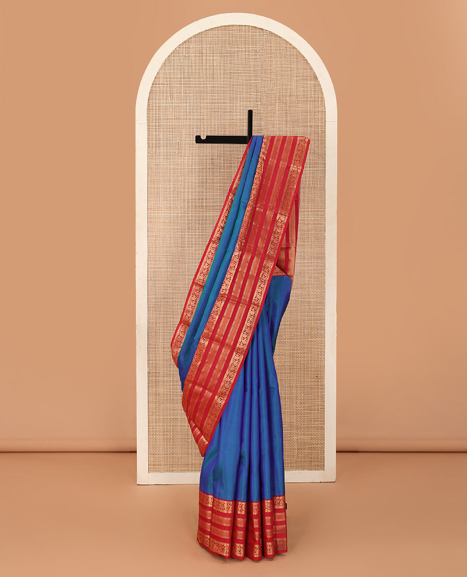 Blue plain Kanchipuram silk saree, contrast border of muthu, neli, and kodi visiry designs, and diagonally woven pallu