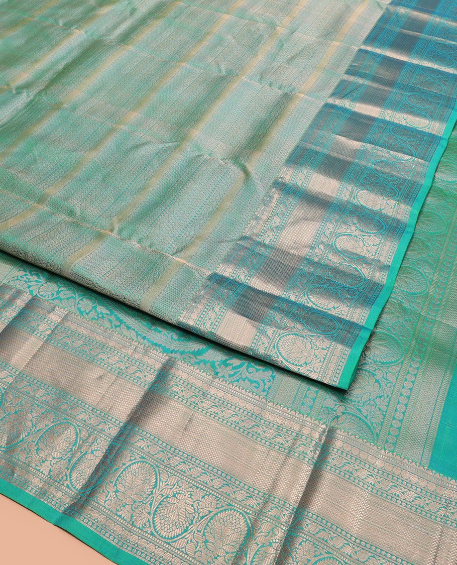 Green Kanchipuram Wedding Silk Saree Decorated with Jacquard Designs, Highlighted with a Zari Border of Rekku, Muthu, Rudraksham, Mayil Kann, and Dhavani Kodi Designs, Artfully Detailed Pallu, and Paired with a Matching Blouse