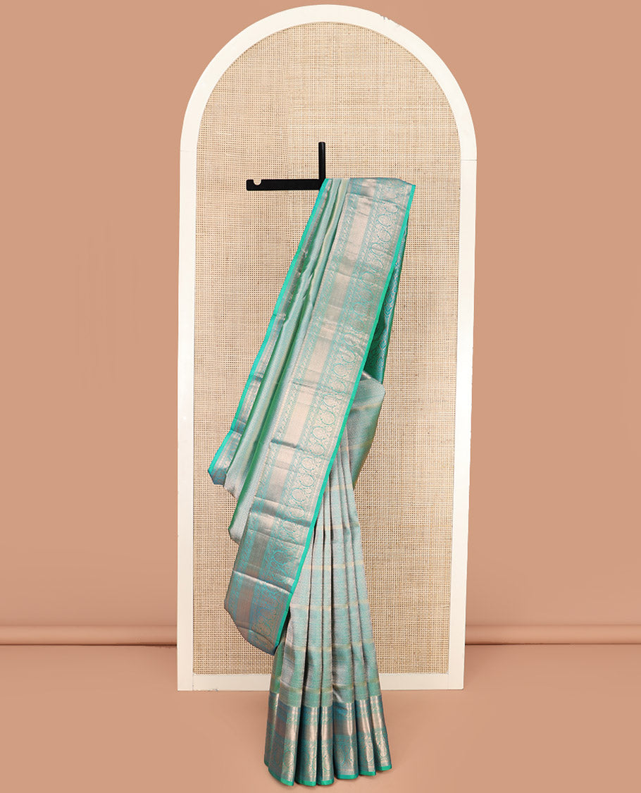 Green Kanchipuram Wedding Silk Saree Decorated with Jacquard Designs, Highlighted with a Zari Border of Rekku, Muthu, Rudraksham, Mayil Kann, and Dhavani Kodi Designs, Artfully Detailed Pallu, and Paired with a Matching Blouse