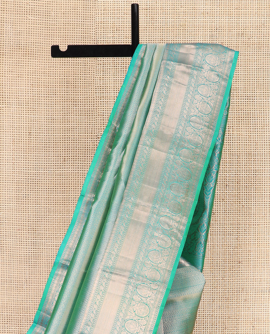Green Kanchipuram Wedding Silk Saree Decorated with Jacquard Designs, Highlighted with a Zari Border of Rekku, Muthu, Rudraksham, Mayil Kann, and Dhavani Kodi Designs, Artfully Detailed Pallu, and Paired with a Matching Blouse