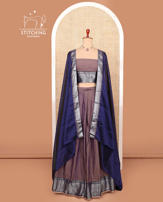 Brown plain cotton half-saree with traditional bordered skirt, matching blouse, and a contrast traditional bordered dhavani