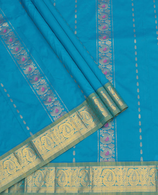 Blue Art Silk Pavadai Material Set, Delicately Woven with Zari Designs on Its Skirt, Complemented by a Contrast Paisley Zari Border, and a Matching Blouse