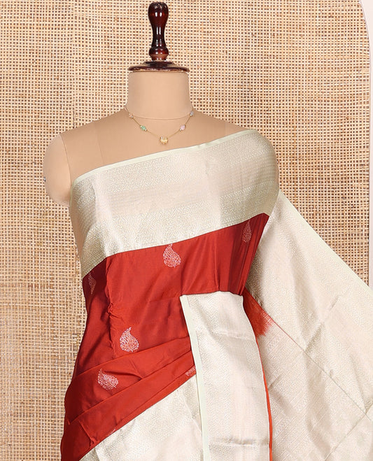 Rust Orange Budget Silk Saree, Bedecked with Zari Buttas All Over Its Body, Complemented by Contrast Border of Traditional Designs Woven in Zari, Sparsely Sparkled Pallu, and Paired with a Contrast Blouse