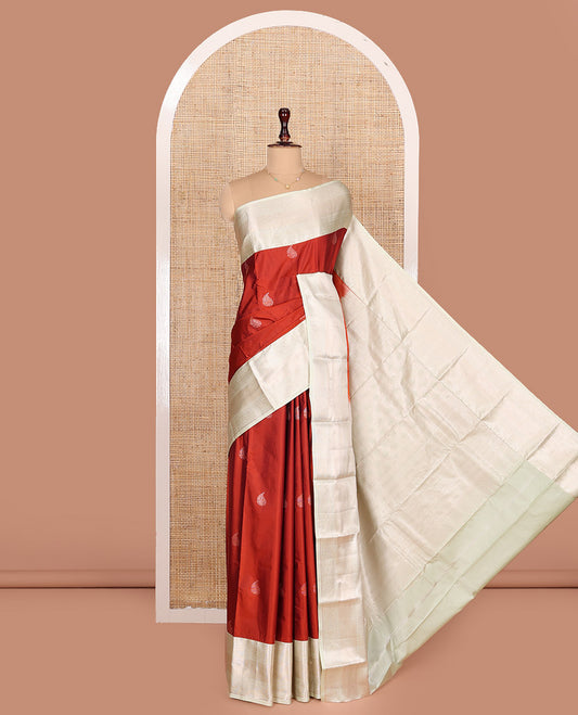 Rust Orange Budget Silk Saree, Bedecked with Zari Buttas All Over Its Body, Complemented by Contrast Border of Traditional Designs Woven in Zari, Sparsely Sparkled Pallu, and Paired with a Contrast Blouse