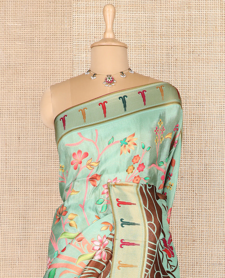 Pastel green colorful floral vine printed dola silk saree, muniya border, and tropical floral printed pallu