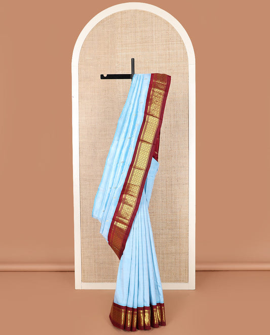 Blue zari buttas Kanchipuram silk saree, contrast one-sided korvai border of thilakam mokku, banaras, and jaal designs, and zari design pallu