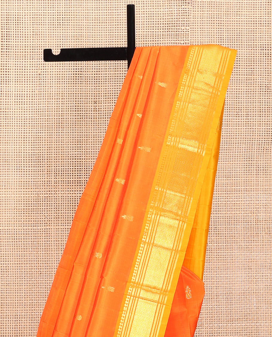 Orange Kanchipuram Silk Saree, Embellished with Zari Buttas, Contrast One-Sided Border of Paneer Sombu, Banaras, Muthu, and Mayil Kann Design, Zari Design Pallu, and No Blouse