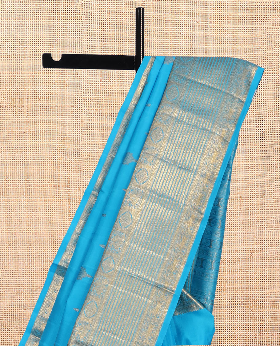 Blue Kanchipuram Silk Saree, Mesmerized with Zari Buttas, Highlighted by Zari Border of Thilakam Mokku, Kathir, Mayil, Chakram, and Yaali, Grand Pallu, and Matching Blouse