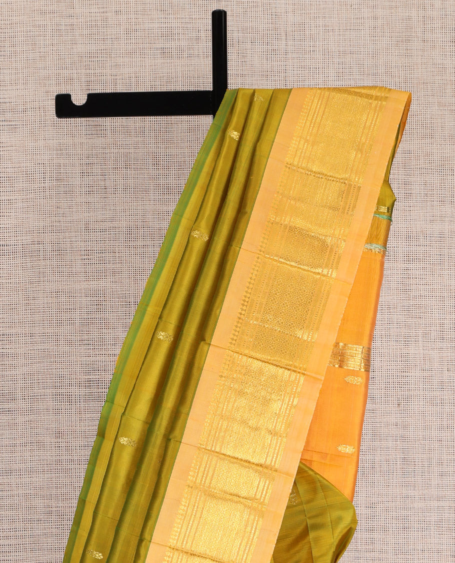 Green Kanchipuram Silk Saree, Accentuated with Zari Buttas, a Contrast One-sided Border of Panner Sombu, Banaras, Muthu, and Jaal Designs, Pallu of Zari Designs, and No Blouse