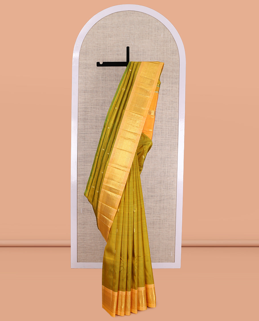 Green Kanchipuram Silk Saree, Accentuated with Zari Buttas, a Contrast One-sided Border of Panner Sombu, Banaras, Muthu, and Jaal Designs, Pallu of Zari Designs, and No Blouse