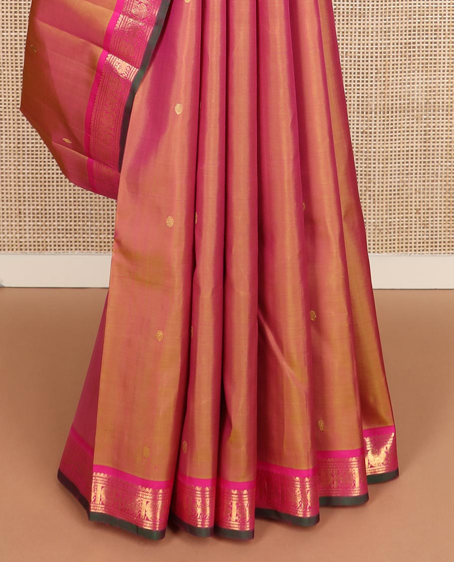 Orange zari buttas Kanchipuram silk saree, contrast border of thilakam mokku, maan, and mayil designs, and intricate pallu