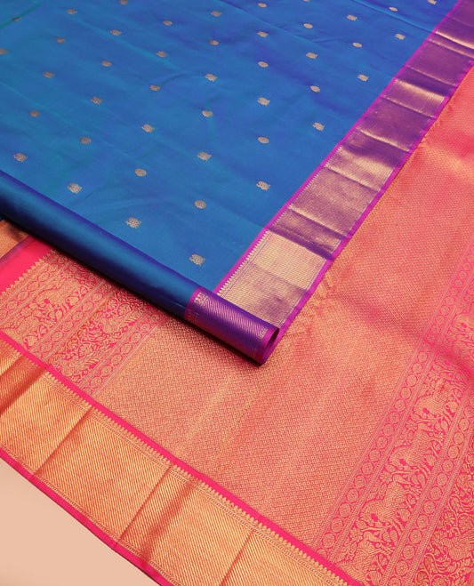 Blue mayil chakram buttas Kanchipuram silk saree, contrast border of thilakam mokku, banaras, muthu, and zari stripes, and mayil kann pallu