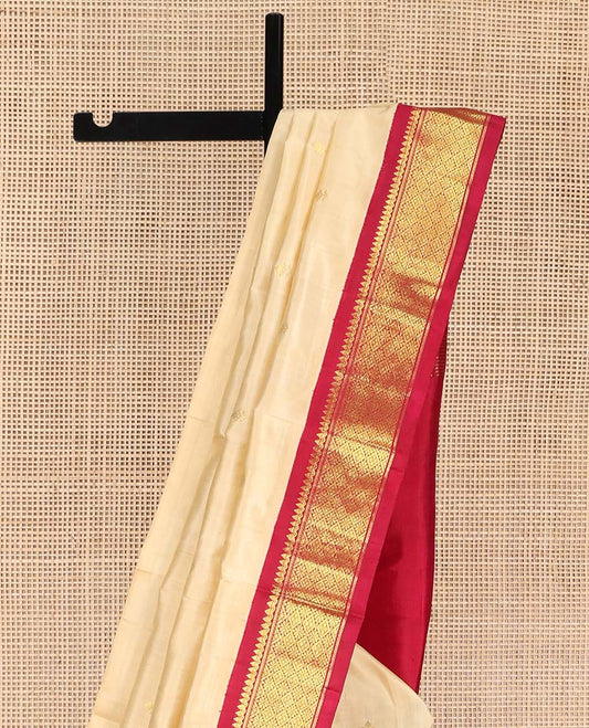Sandal Kanchipuram Silk Saree, Sparsely Woven with Zari Buttas on Its Body, Complemented by Contrast One-Sided Border of Thilakam Mokku, and Jaal Designs, Pallu of Zari Designs, and Comes Without a Blouse