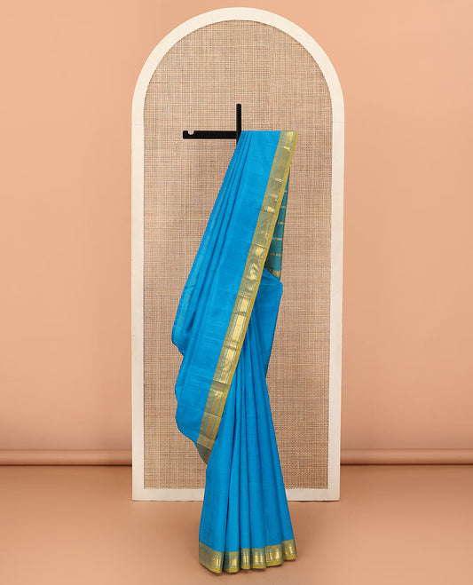 Blue Plain Kanchipuram Silk Saree, Complemented by Contrast One-Sided Border of Rekku, Banaras, and Mayil Kann Designs, Pallu Elevated with Zari Designs, and Comes Without a Blouse
