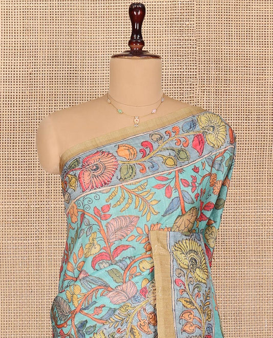 Turquoise Semi-Tussar Saree Detailed with Kalamkari-Style Colorful Floral Print, Complemented by a Contrast Floral Printed Border, Pallu Depicting Krishna and Gopis Print, and Paired with a Matching Printed Blouse