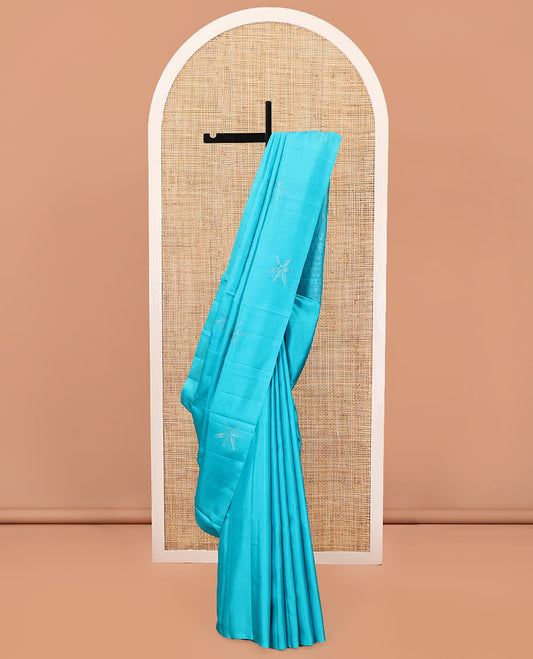 Borderless Blue Mayuri Soft Silk Saree, Sparsely Woven with Floral Buttas All Over Its Body, Sparsely Sparkled Pallu, and Paired with a Matching Blouse