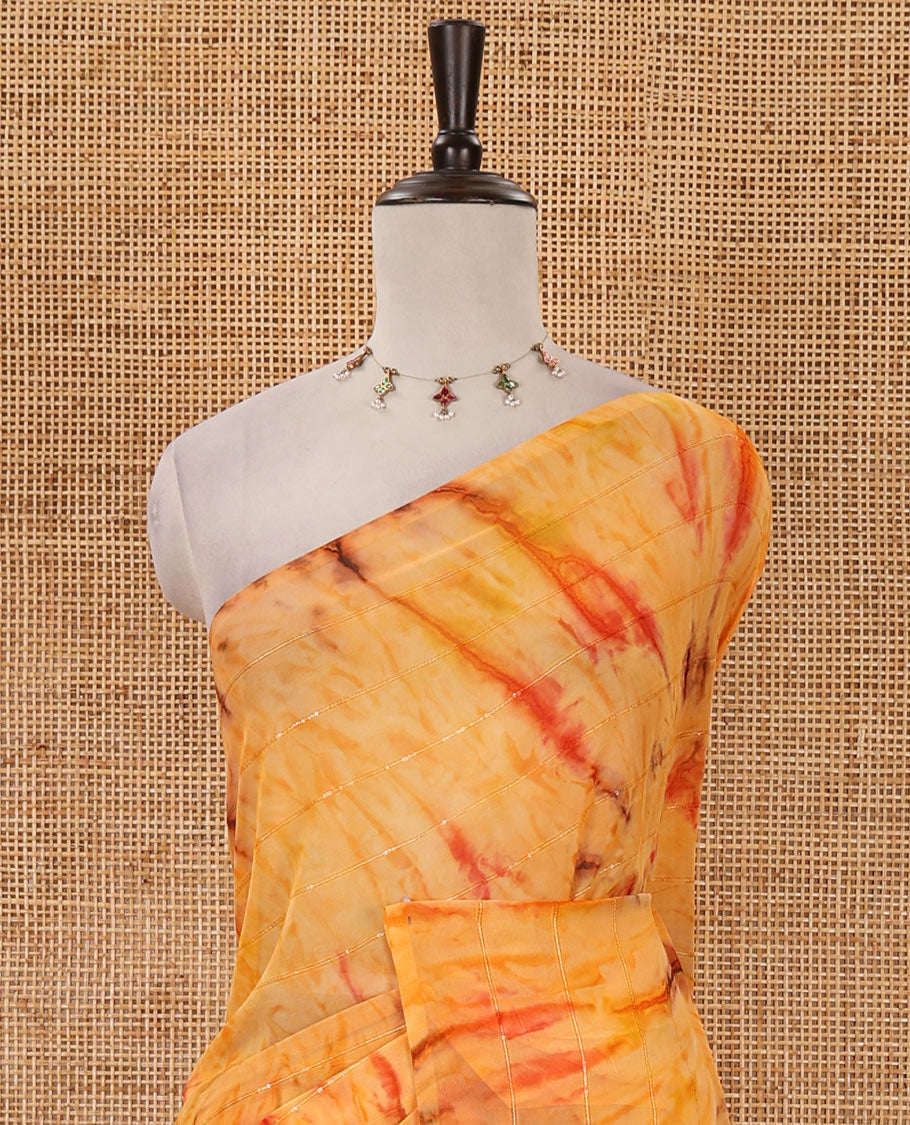 Borderless orange shibori-style printed & sequins work marble chiffon saree, self-pallu with tassels & contrast embroidered blouse