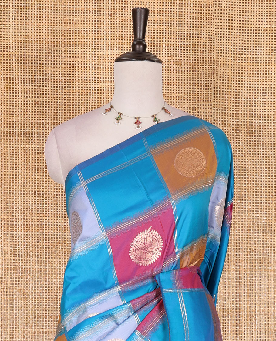 Borderless blue chakra buttas enclosed, checked elite soft silk saree, contrast ogee patterned pallu, and contrast zari design blouse