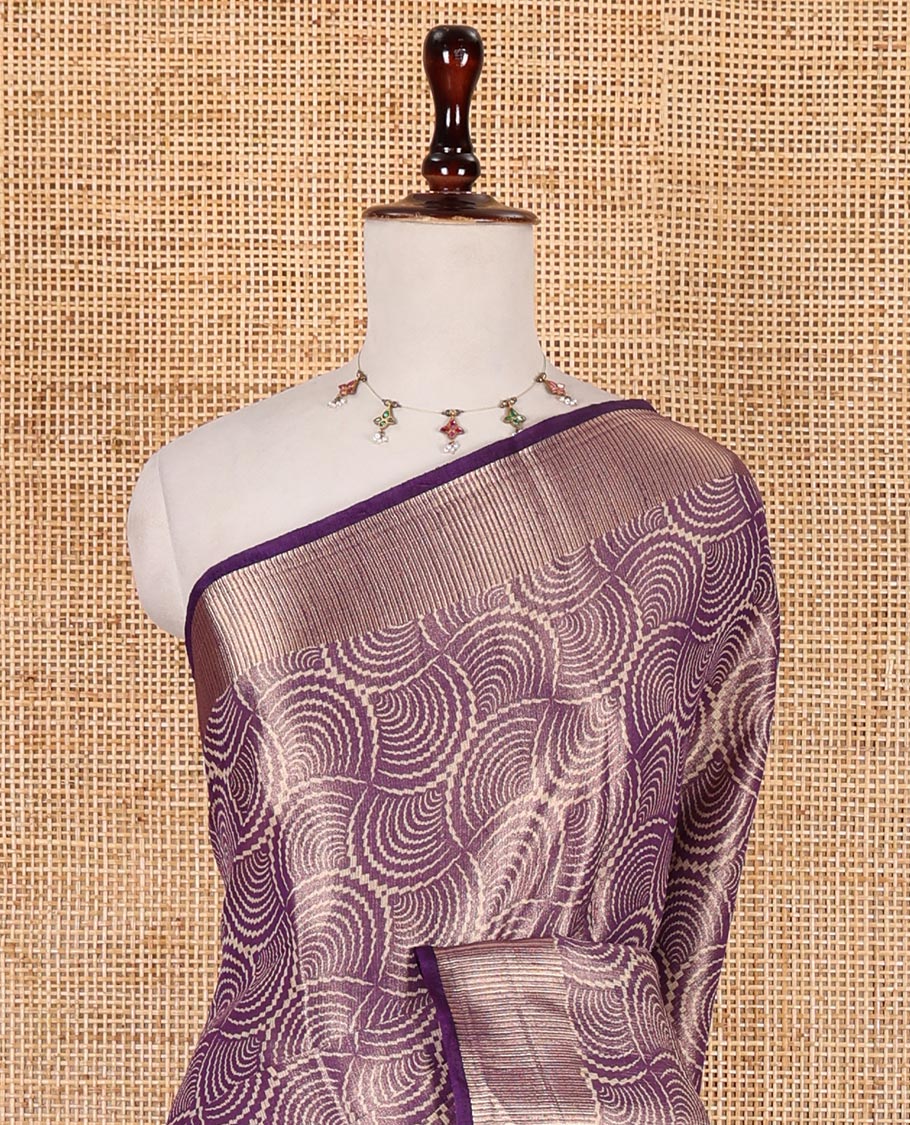 Purple scallop design tissue saree, zari striped border, striped pallu, and gleaming matching blouse