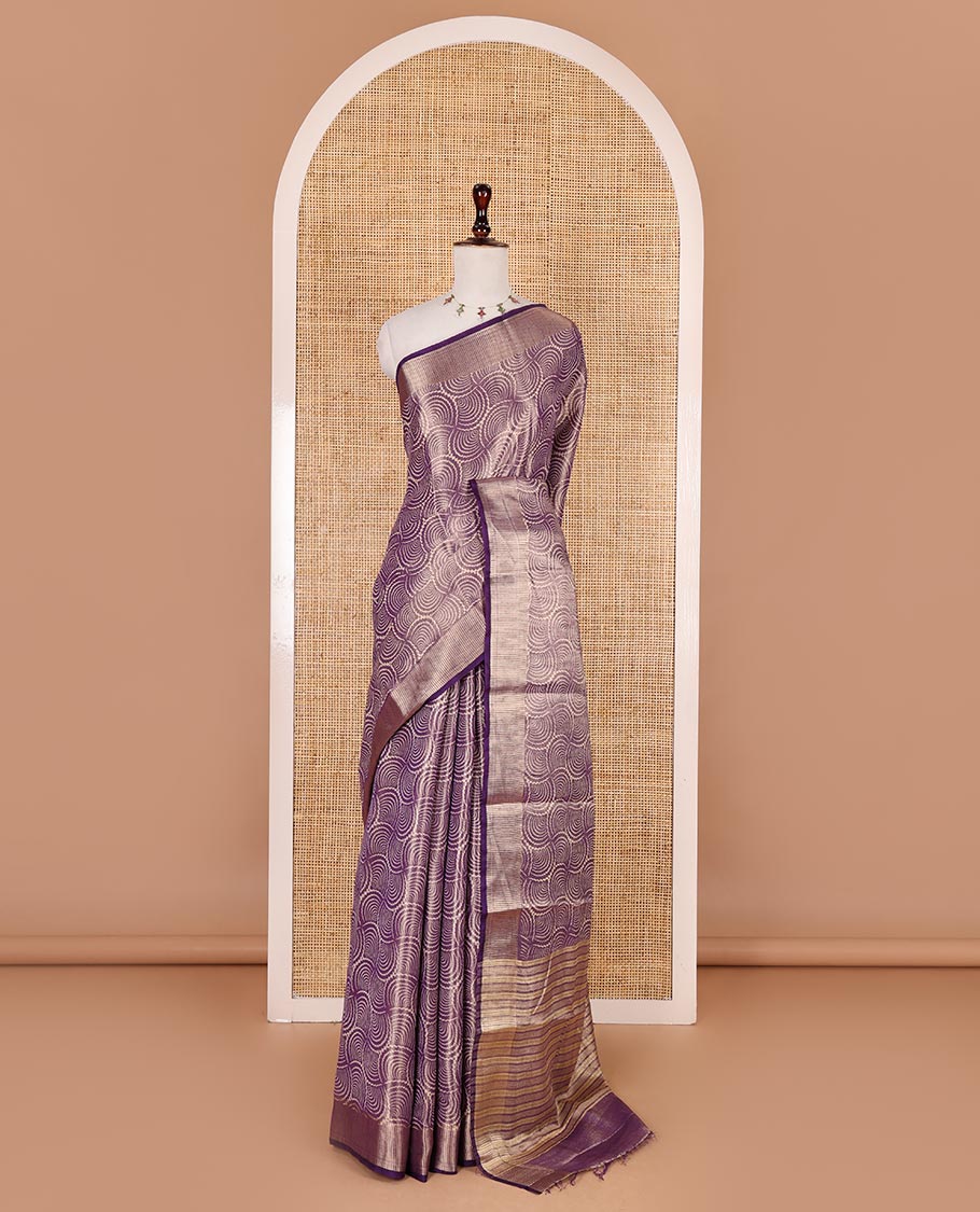 Purple scallop design tissue saree, zari striped border, striped pallu, and gleaming matching blouse