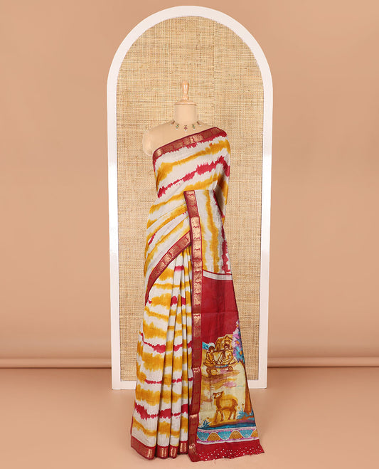 Yellow shibori printed muslin cotton saree, contrast peacock zari border, village scenery printed pallu, and a contrast polka dotted zari border blouse