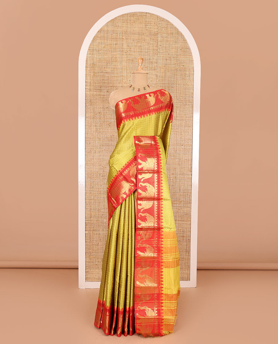 Yellow zari checked semi-taffeta saree, contrast satin temple border of elephant motifs, striped pallu, and a contrast striped blouse