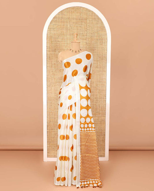 Borderless cream and orange polka dots printed art khadi cotton saree, pallu steeped with polka dots, and a contrast tiny polka dots printed blouse