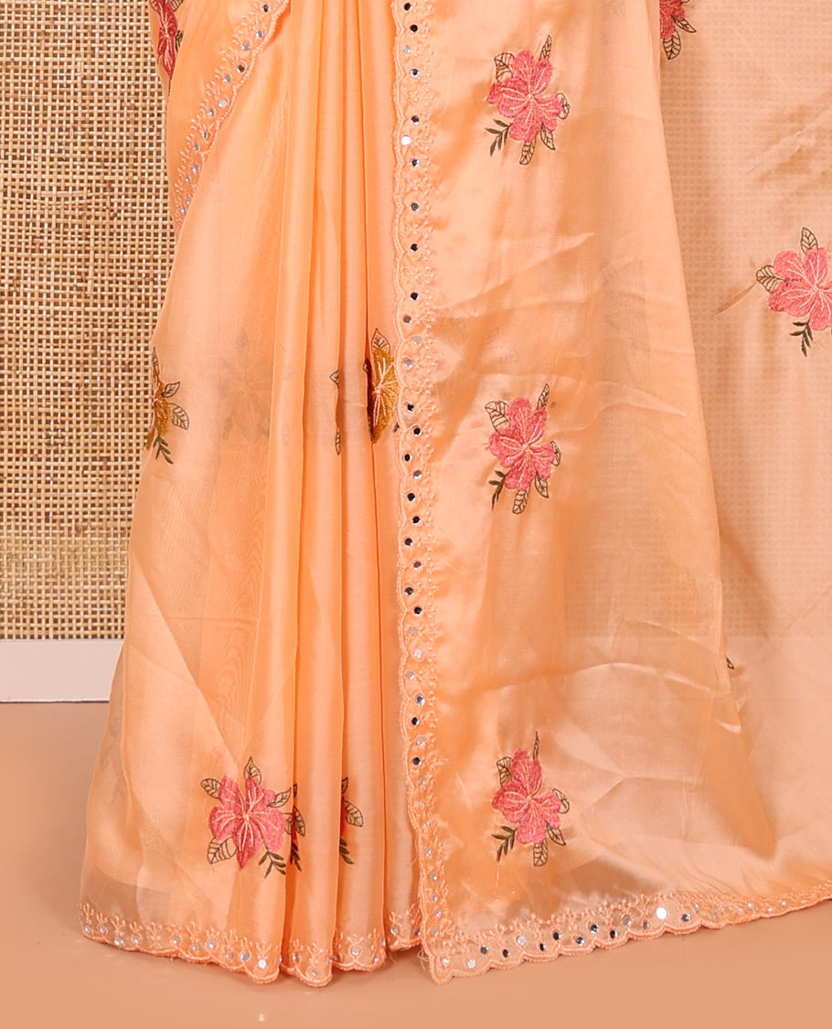 Orange floral motifs embroidered rangoli chiffon saree with mirror work border, embroidered pallu, and a contrast intricate scallop design embroidered blouse