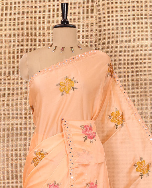 Orange floral motifs embroidered rangoli chiffon saree with mirror work border, embroidered pallu, and a contrast intricate scallop design embroidered blouse