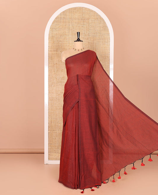 Borderless Maroon Plain Khadi Mul Cotton Saree Features a Self-Pallu with Tassels, and a Matching Blouse