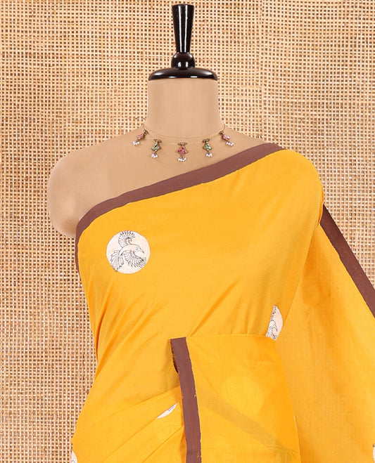 Yellow South Cotton Saree Featuring Eagle Motifs Enclosed Circles, Highlighted with a Contrast Border, and a Contrast Floral Motifs Block Printed Blouse