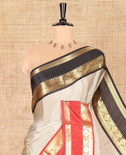 Light Chikku Semi-Soft Silk Saree Embellished with Micro-Checks on Its Body, Complemented by a Contrast Rettai Pettu Zari Border of Paisley, and Chakram Designs, Subtly Striped Pallu, and Paired with a Contrast Blouse