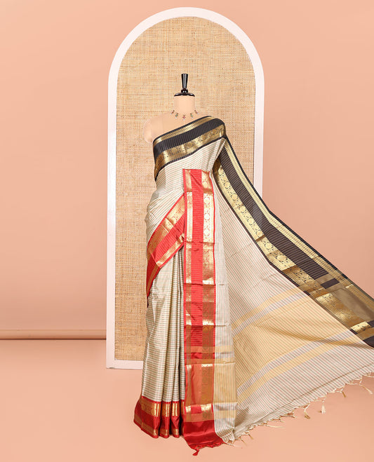 Light Chikku Semi-Soft Silk Saree Embellished with Micro-Checks on Its Body, Complemented by a Contrast Rettai Pettu Zari Border of Paisley, and Chakram Designs, Subtly Striped Pallu, and Paired with a Contrast Blouse