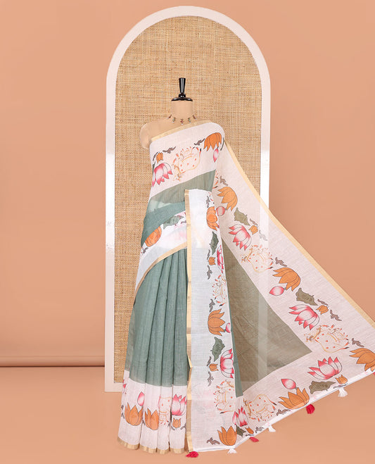 Green Plain Linen Cotton Saree, Complemented by a Contrast Border Depicting Pichwai Cow and Lotus Motifs Print, Pallu of the Same Body Print, and Paired with a Contrast Blouse