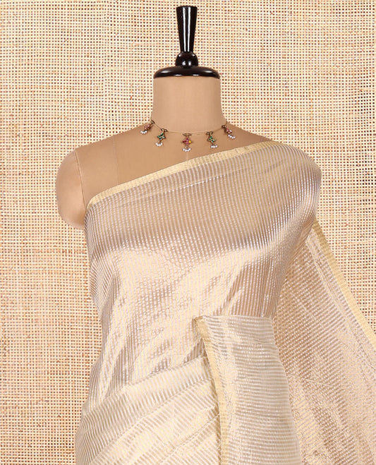 Borderless Off-white Tissue Saree, Steeped with Thin Vertical Zari Stripes All Over Its Body, Highlighted by Gleaming Zari Striped Pallu, and Paired with a Matching Blouse