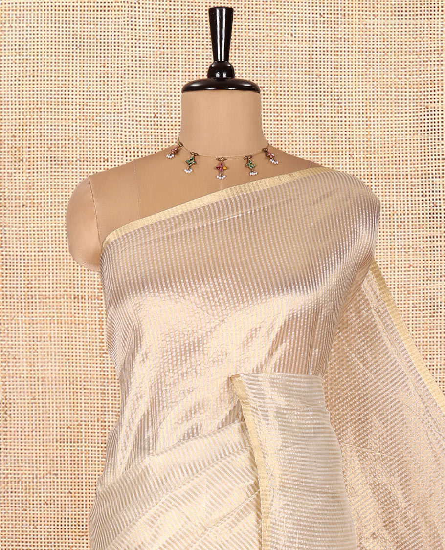 Borderless Off-white Tissue Saree, Steeped with Thin Vertical Zari Stripes All Over Its Body, Highlighted by Gleaming Zari Striped Pallu, and Paired with a Matching Blouse