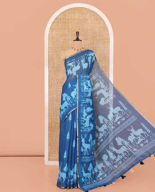 Blue Christmas-Themed Linen Cotton Saree, Bedecked with Christmas Tree Motifs Printed on Its Body, a Subtle Piping Border, Pallu of Christmas-Themed Print, and Paired with a Contrast Floral Printed Blouse