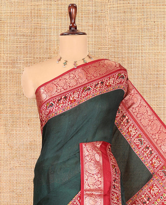 Green Embossed Moss Chiffon Saree, Complemented by a Contrast Traditional Zari Patola Printed Border, Patola Pallu, and a Contrast Blouse